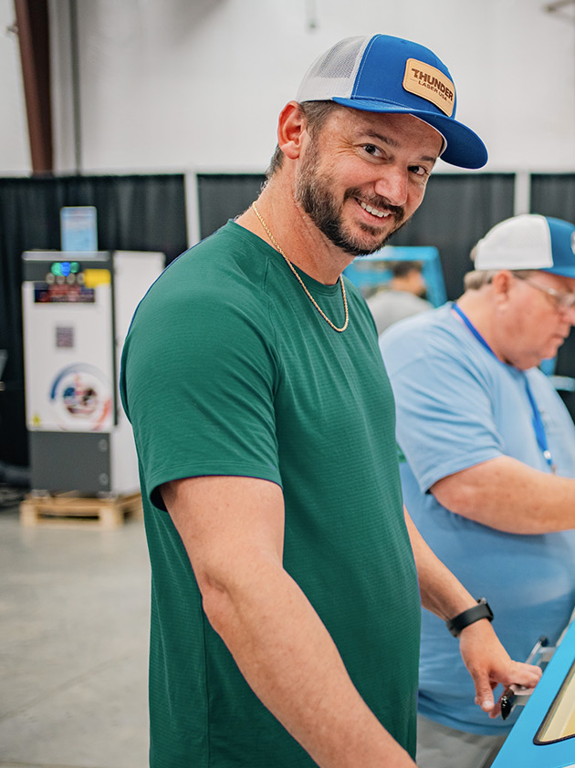 Clay Luttrell smiling while visiting a manufacturing workspace