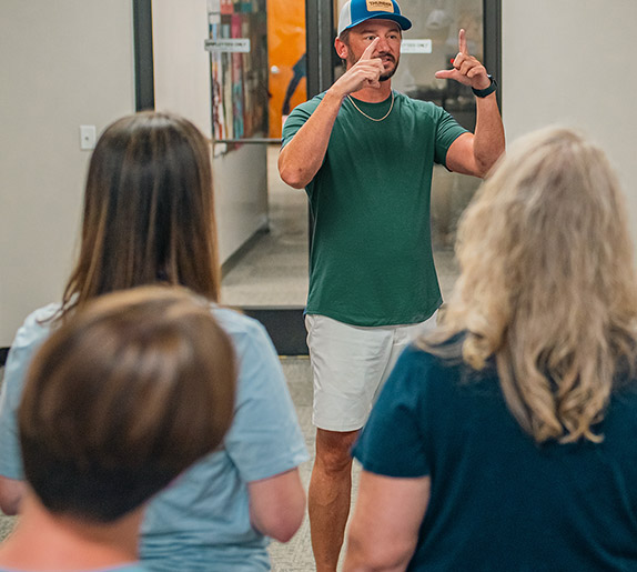 Clay Luttrell speaking to a seated group at a workshop